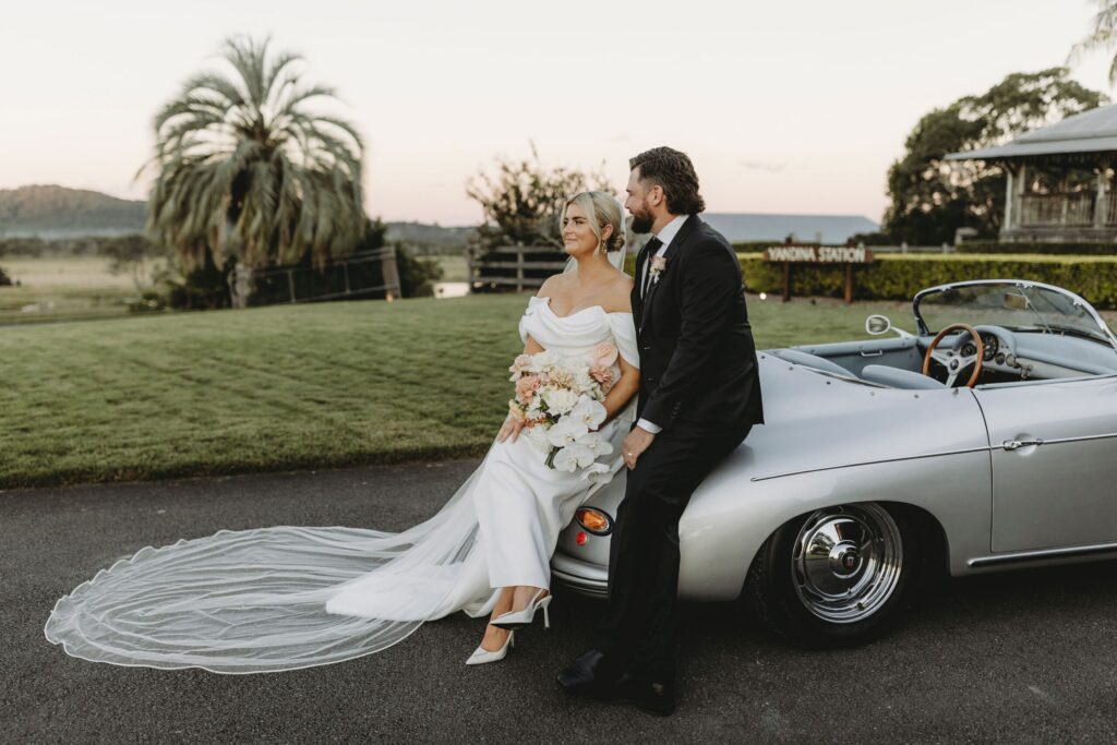 couple sitting on bonnet at yandina station wedding ceremony