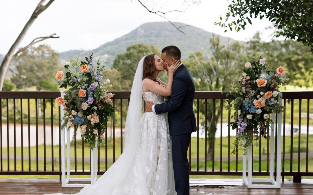 Bride and groom embracing at a hinterland wedding venues on the Sunshine Coast with mountain views