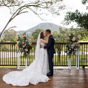 Bride and groom embracing at a hinterland wedding venues on the Sunshine Coast with mountain views